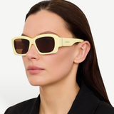 KABE SHOP INC Croisiere rectangular sunglasses in sand acetate with brown lenses worn by a woman