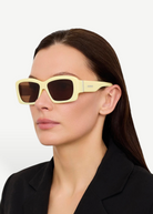 KABE SHOP INC Croisiere rectangular sunglasses in sand acetate with brown lenses worn by a woman