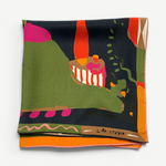 A folded Labyrinth of Horta Scarf featuring an abstract, colorful landscape print with hand-drawn labyrinth shapes in green, black, orange, and pink.