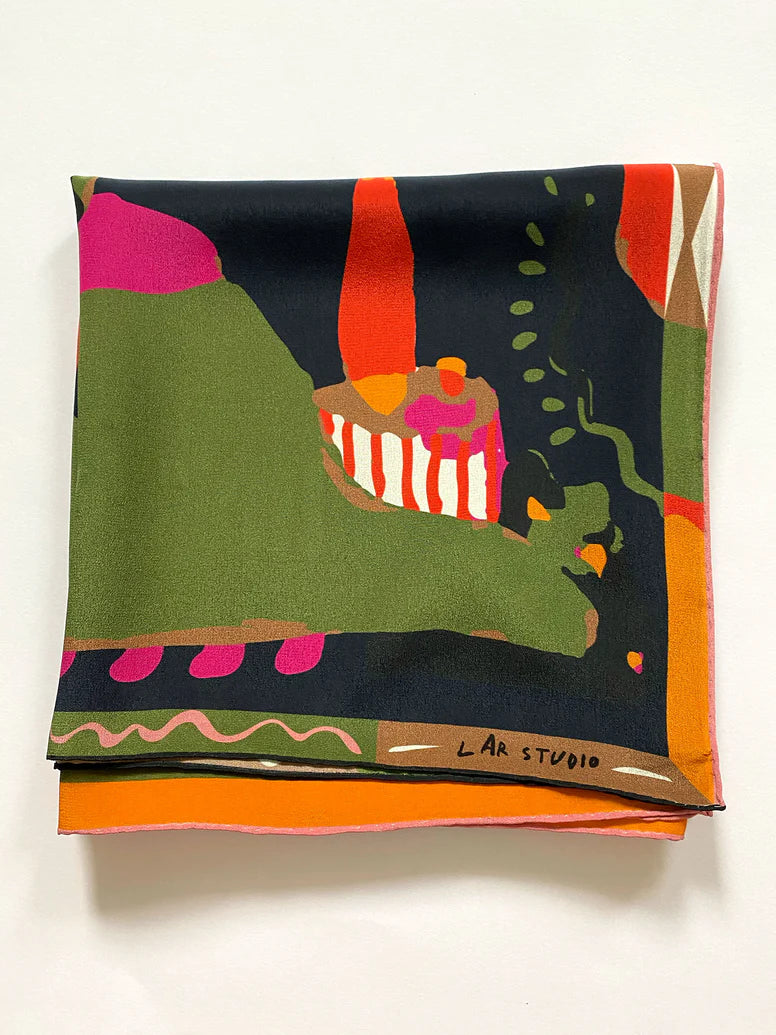 A folded Labyrinth of Horta Scarf featuring an abstract, colorful landscape print with hand-drawn labyrinth shapes in green, black, orange, and pink.