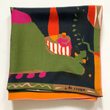 A folded Labyrinth of Horta Scarf featuring an abstract, colorful landscape print with hand-drawn labyrinth shapes in green, black, orange, and pink.