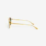 Side view of Miranda Sunglasses, featuring gold-plated frames with green lenses, displayed against a plain white background. The thin Japanese titanium arms are gently curved at the ends, enhancing the modern, sleek look of the oversized design.