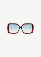 The Macy Sunglasses feature a square, oversized silhouette with a tortoiseshell acetate frame and blue gradient lenses, displayed facing forward against a plain white background.
