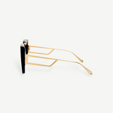 Side view of the Macy Sunglasses with gold geometric temples and black oversized frames, featuring aqua gradient lenses, displayed on a plain white background.