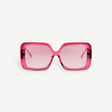 Front view of the Macy Sunglasses, showcasing oversized, square-shaped frames crafted from luxurious Italian acetate in translucent pink, complemented by matching pink-tinted lenses and elegant gold plated temples, set against a plain white background.