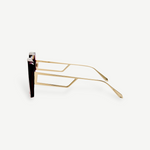 Macy Sunglasses with gold-plated temples, geometric cut-out temple arms, and dark lenses are shown in a side profile view against a plain white background.