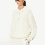 KABE SHOP INC oversized cream French terry half-zip polo sweatshirt worn by a model in black glasses