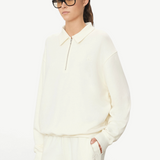 KABE SHOP INC oversized cream French terry half-zip polo sweatshirt worn by a model in black glasses