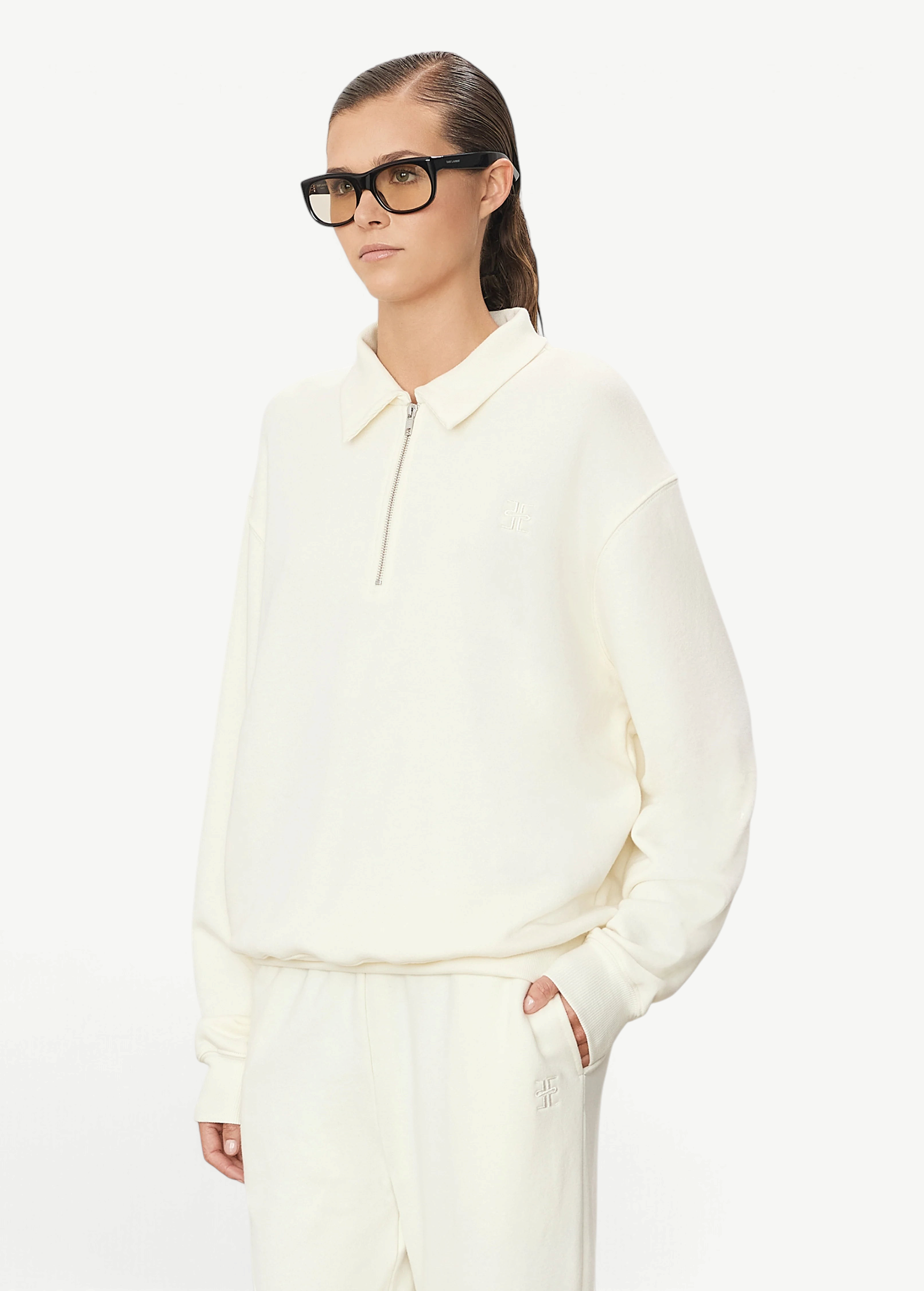 KABE SHOP INC oversized cream French terry half-zip polo sweatshirt worn by a model in black glasses