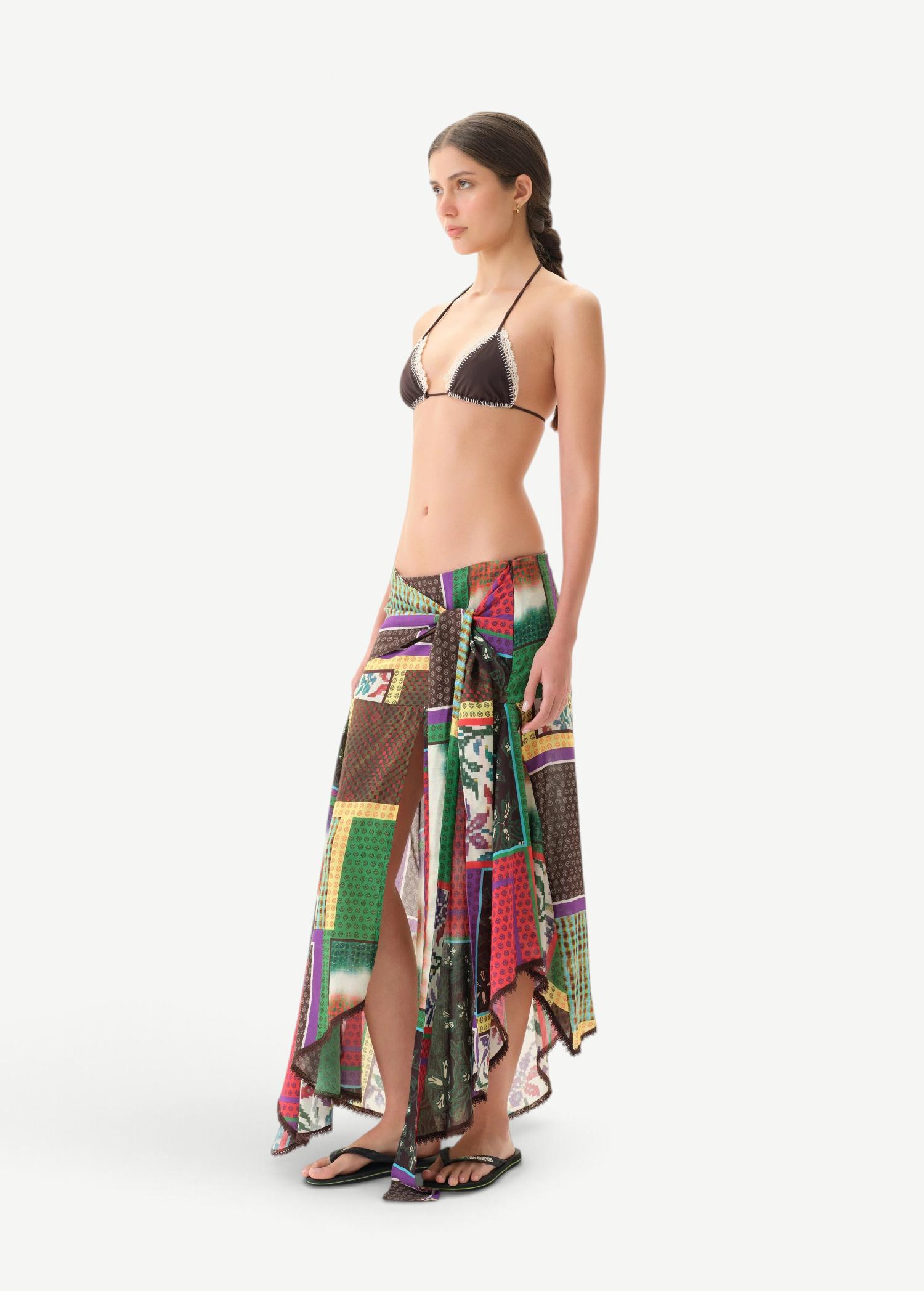 KABE SHOP INC Lumier skirt featuring a vibrant patchwork print, asymmetrical hem, and delicate lace trim on a model