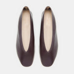 A pair of Luna Slipper Shoes in dark brown leather, featuring slip-on styling with almond-shaped openings, slightly square toes, and subtle leather detailing, displayed from above on a white background.