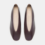 A pair of Luna Slipper Shoes in dark brown leather, featuring slip-on styling with almond-shaped openings, slightly square toes, and subtle leather detailing, displayed from above on a white background.