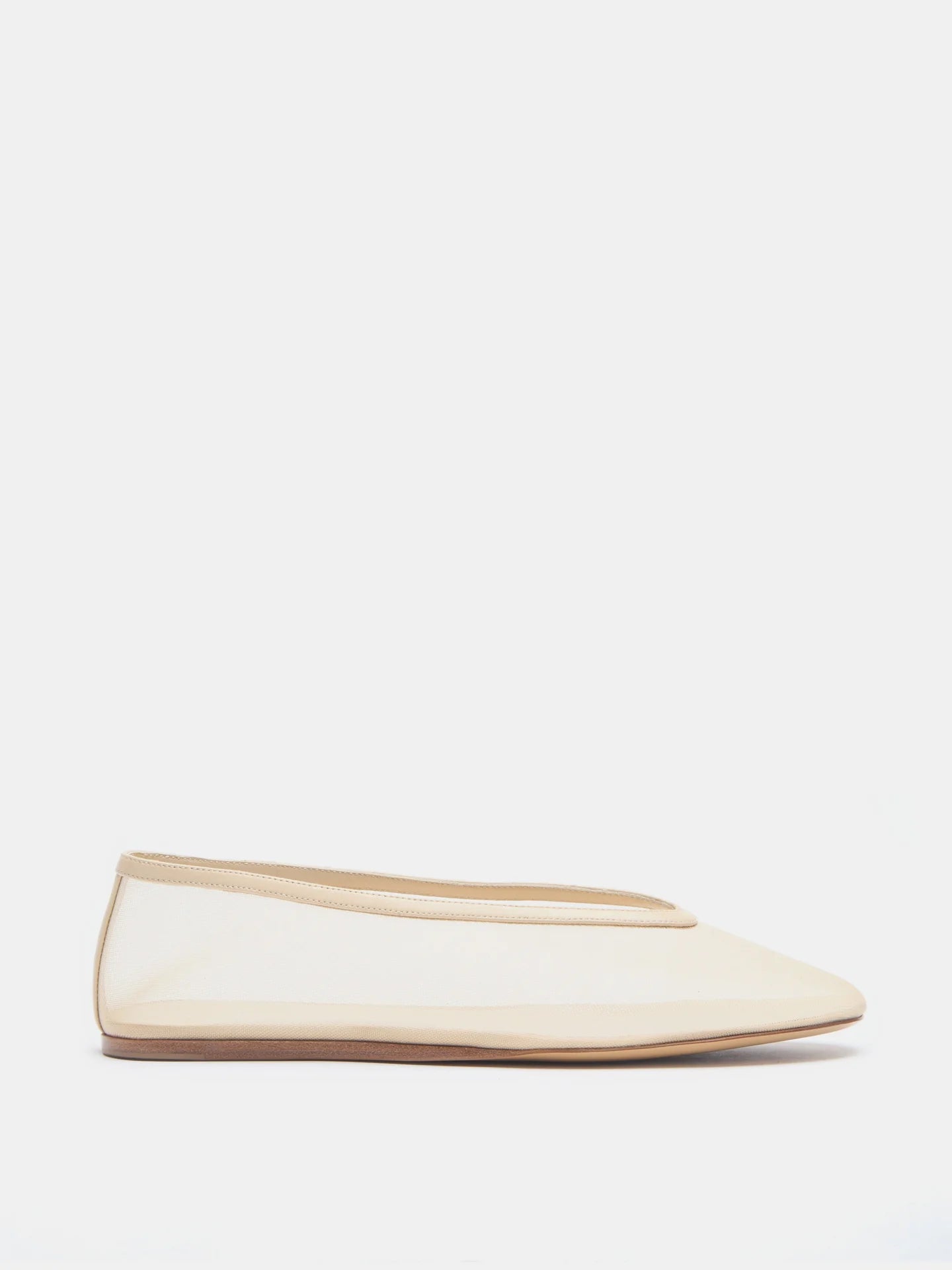 Luna Slipper Shoes in beige feature a minimalist design with a slightly pointed toe, low heel, and easy slip-on style, crafted from elegant patent leather and showcased on a plain white background.