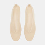A pair of beige, minimalist Luna Slipper Shoes made from patent leather with an elongated oval opening is displayed on a white background, viewed from above.