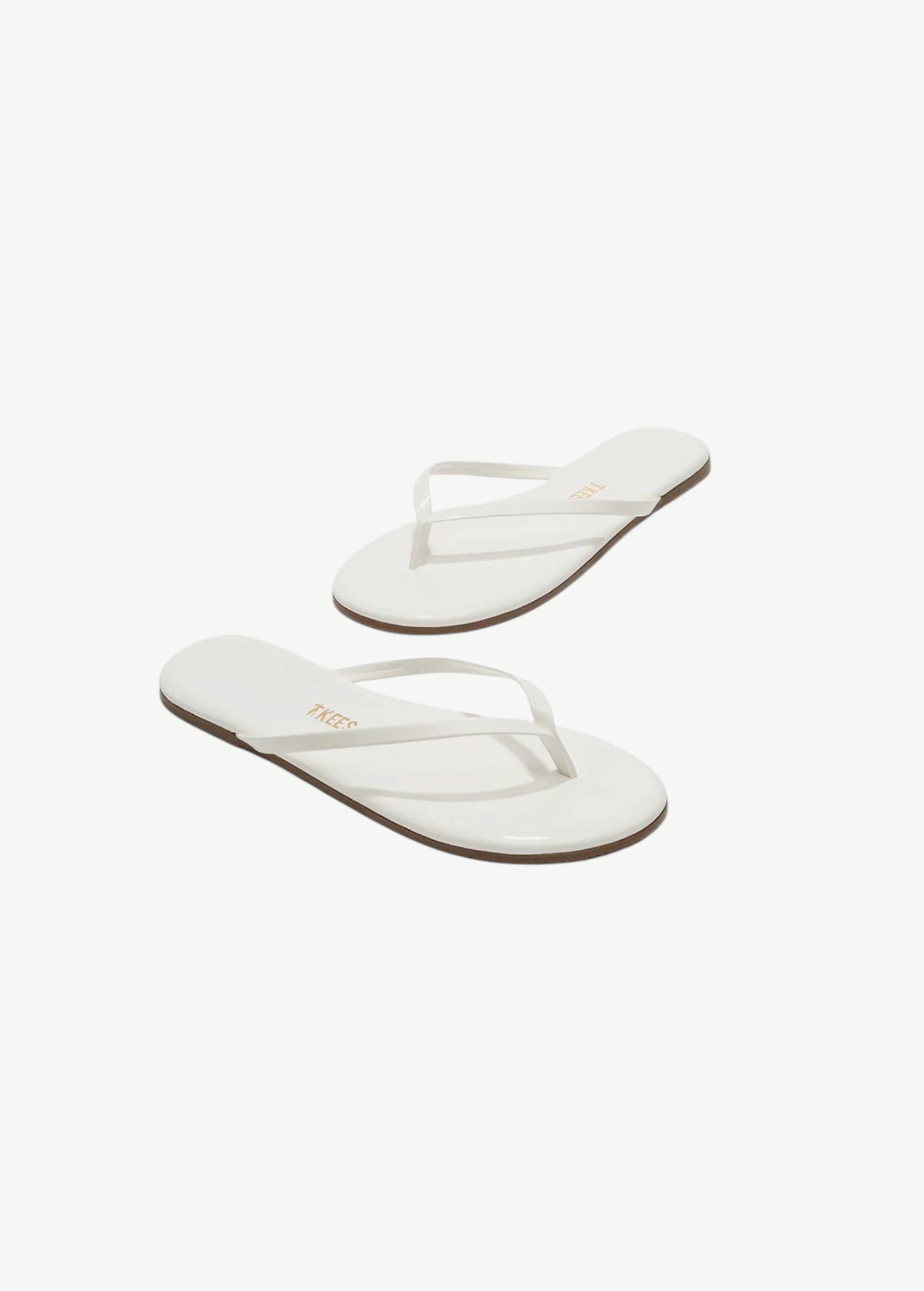 KABE SHOP INC Lily Glosses white patent leather flip flops with cushioned insoles and rubber outsoles.