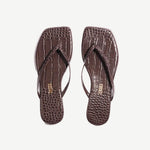 Pair of brown flip-flops with a textured pattern on a white background