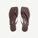 Pair of brown flip-flops with a textured pattern on a white background