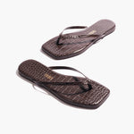 A pair of Square Toe Lily, dark brown crocodile-embossed leather flip-flops with square toes are placed on a white background.