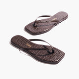 A pair of Square Toe Lily, dark brown crocodile-embossed leather flip-flops with square toes are placed on a white background.