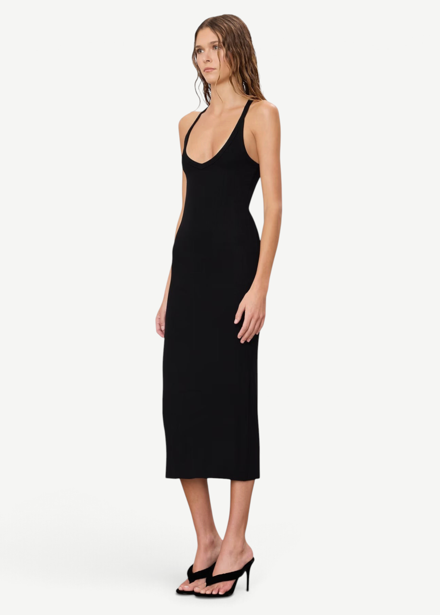Model wearing a KABE SHOP INC black ribbed V-neck racerback midi dress with a slim fit, styled with black heels.