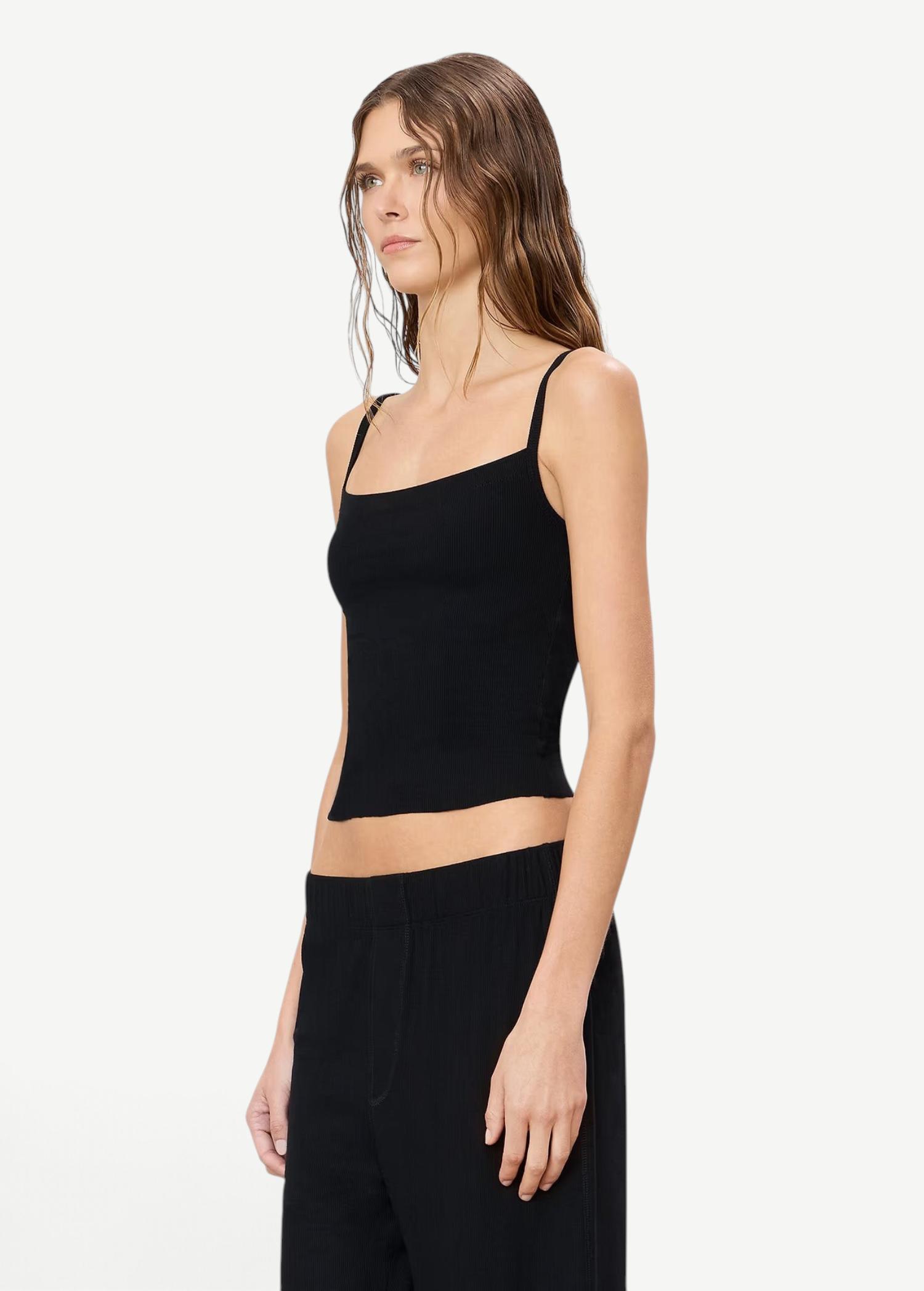 Model wearing a KABE SHOP INC black 90's Tank top in a slim-fit, double-lined modal jersey fabric, side view.