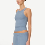 Model wearing a KABE SHOP INC blue ribbed high neck fitted tank top with a slim silhouette.