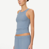 Model wearing a KABE SHOP INC blue ribbed high neck fitted tank top with a slim silhouette.