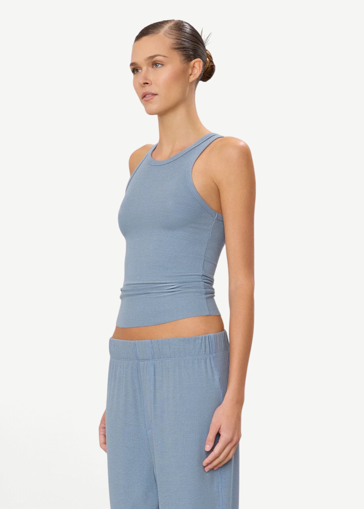 Model wearing a KABE SHOP INC blue ribbed high neck fitted tank top with a slim silhouette.