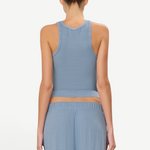 Back view of a woman wearing a KABE SHOP INC blue ribbed high neck fitted tank top with a racerback design.