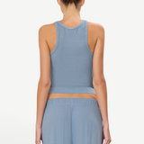 Back view of a woman wearing a KABE SHOP INC blue ribbed high neck fitted tank top with a racerback design.