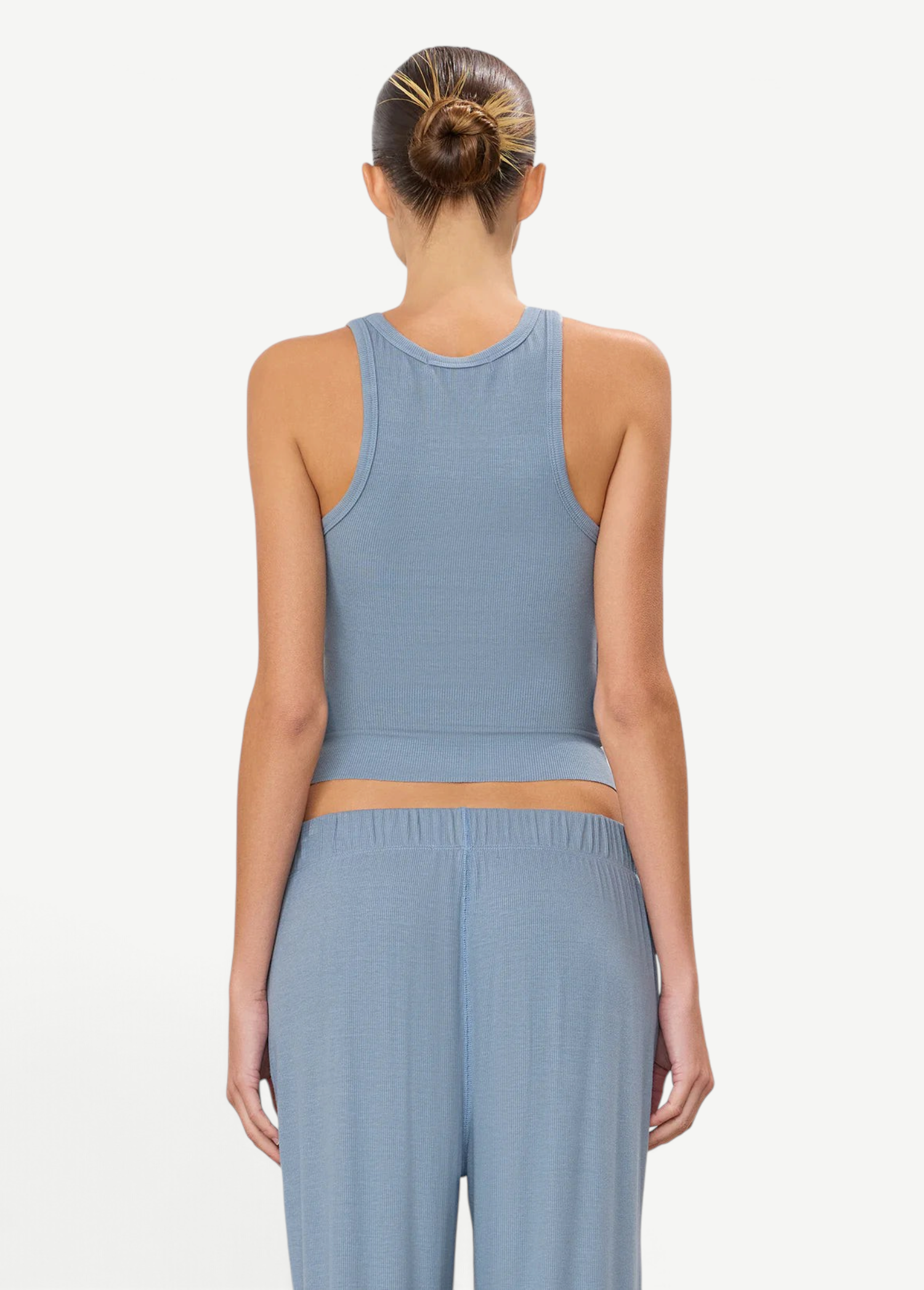 Back view of a woman wearing a KABE SHOP INC blue ribbed high neck fitted tank top with a racerback design.