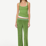 A model wears a green tank top layered over a white tank top with matching low-rise green terry cloth Low Rise Lounge Pant.