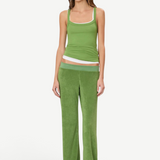 A model wears a green tank top layered over a white tank top with matching low-rise green terry cloth Low Rise Lounge Pant.