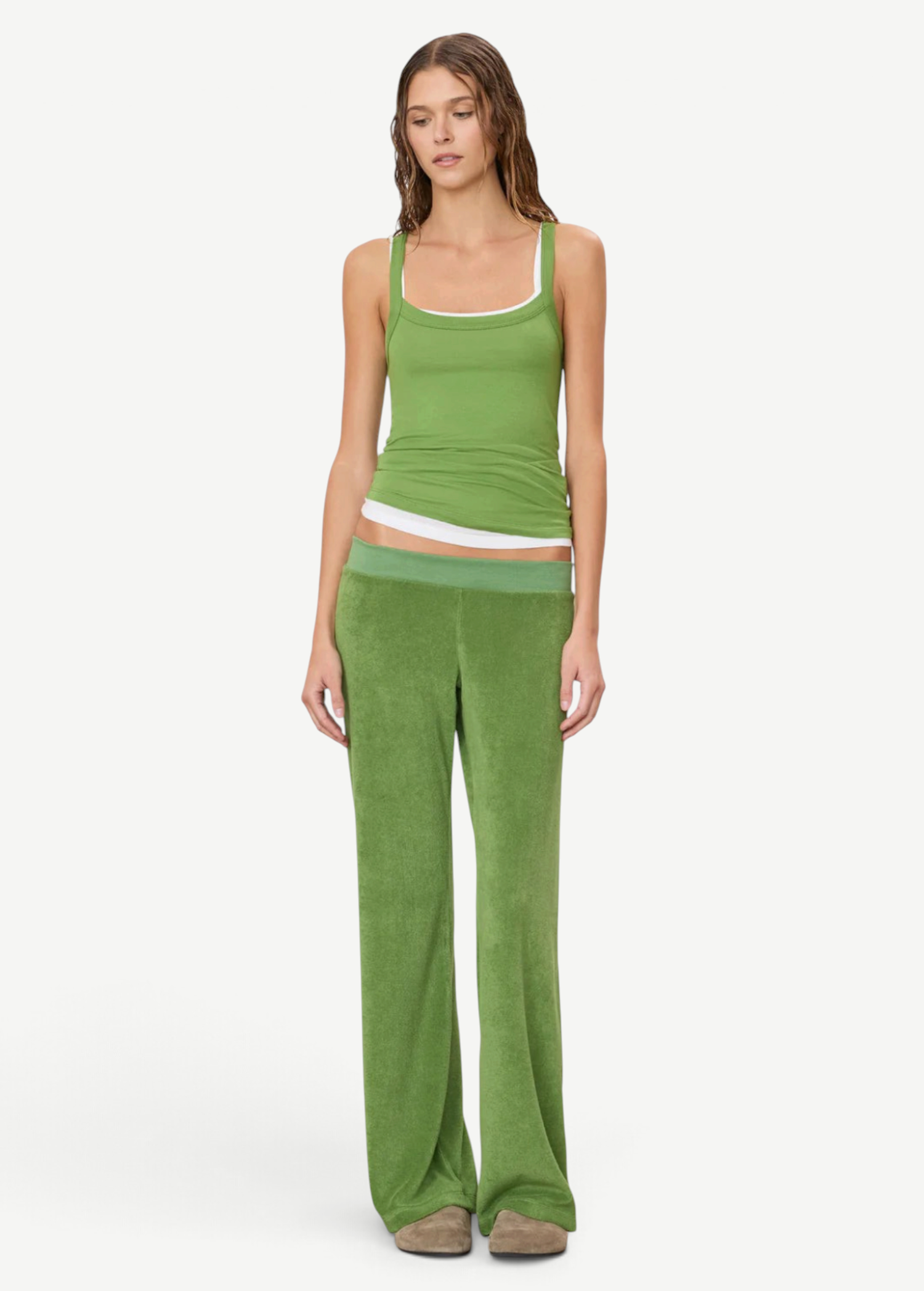 A model wears a green tank top layered over a white tank top with matching low-rise green terry cloth Low Rise Lounge Pant.