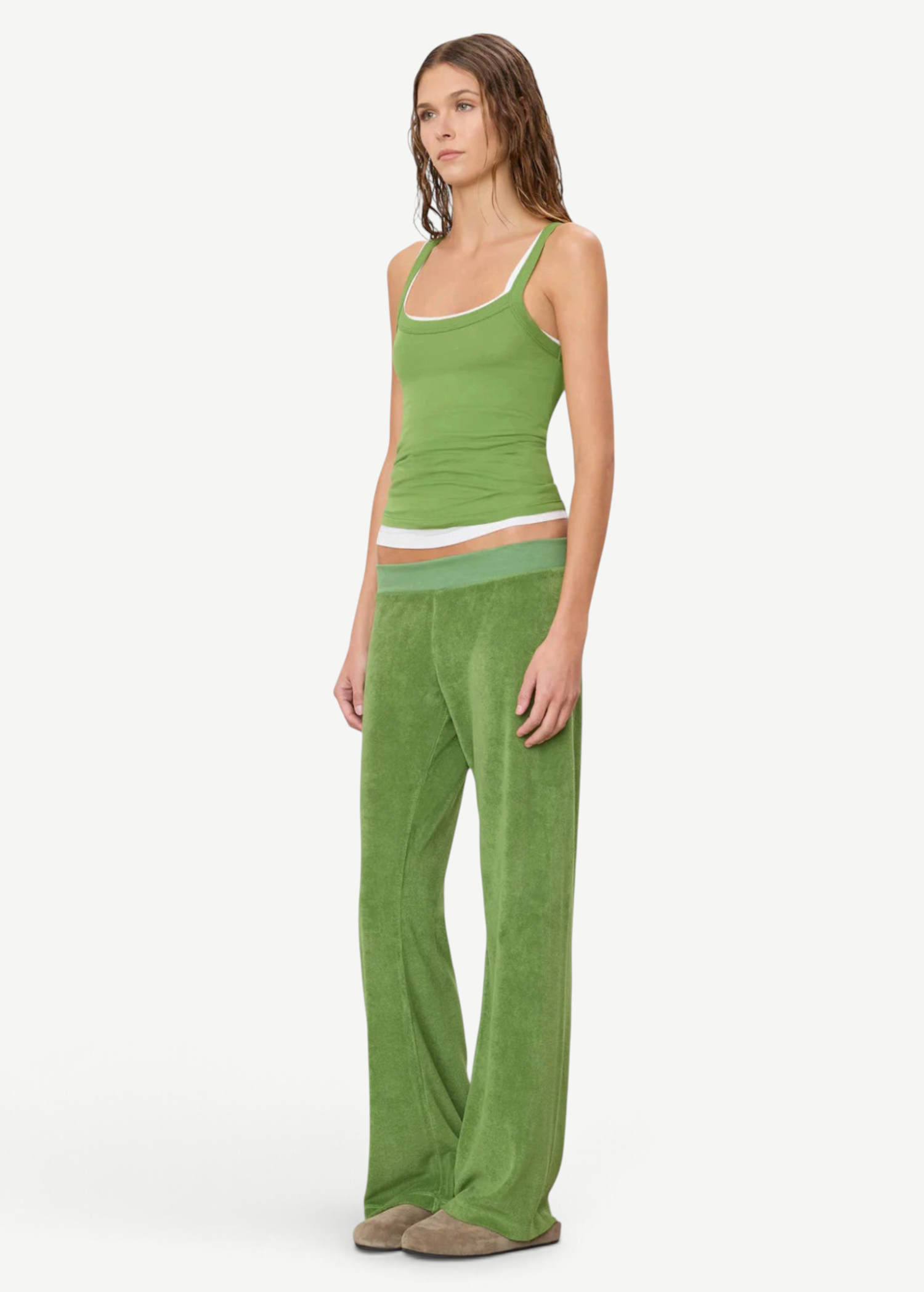 A person wearing a green tank top layered over a white tank top, paired with green wide-leg Low Rise Lounge Pant and tan slip-on shoes.
