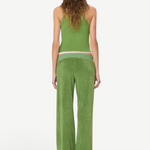 A person seen from behind wears a green tank top and Low Rise Lounge Pant in green, crafted from comfortable wide-leg terry cloth.