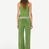 A person seen from behind wears a green tank top and Low Rise Lounge Pant in green, crafted from comfortable wide-leg terry cloth.