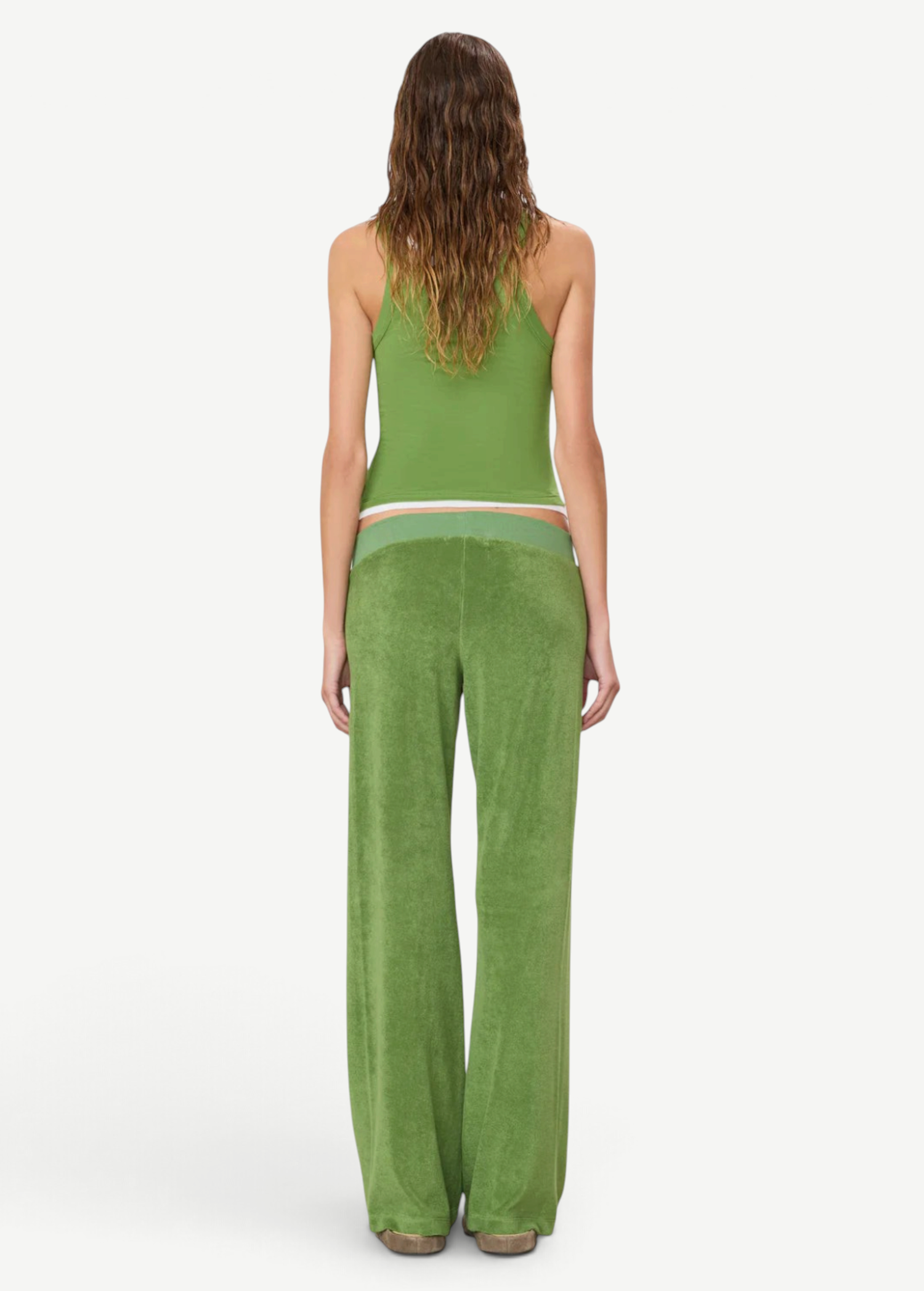 A person seen from behind wears a green tank top and Low Rise Lounge Pant in green, crafted from comfortable wide-leg terry cloth.