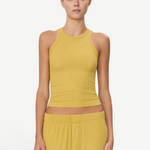 Model wearing a mustard yellow KABE SHOP INC high neck fitted ribbed tank top with a slim silhouette