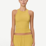 Model wearing a mustard yellow KABE SHOP INC high neck fitted ribbed tank top with a slim silhouette