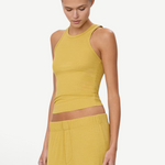 Model wearing a mustard yellow KABE SHOP INC high neck fitted ribbed tank top with a slim silhouette
