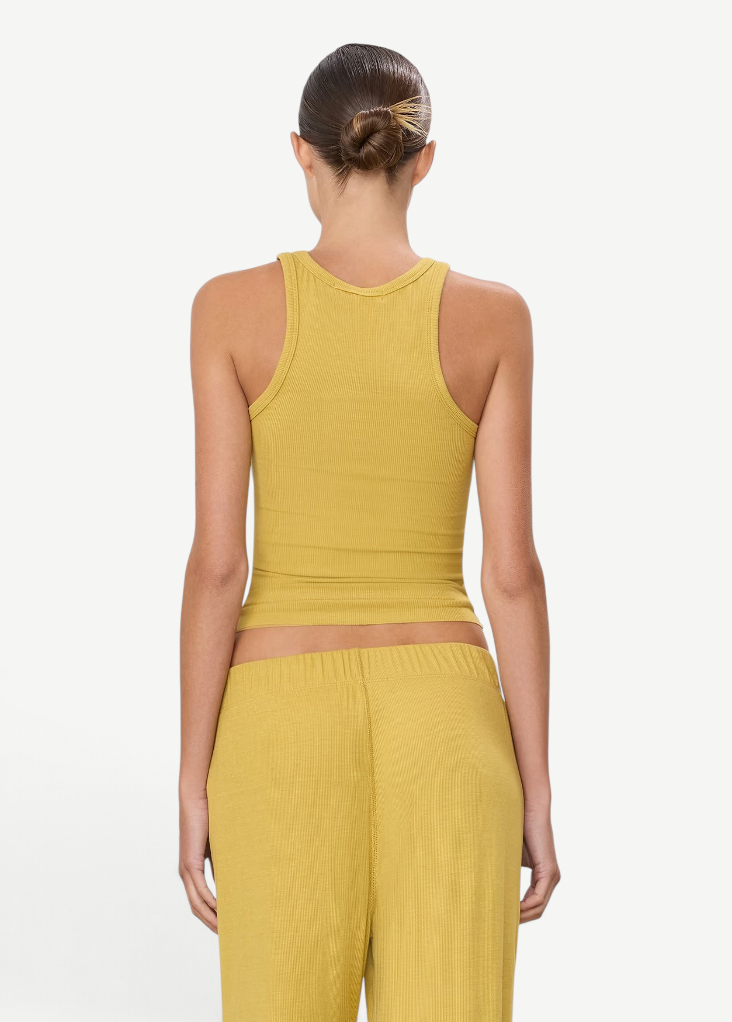 Back view of a woman wearing a KABE SHOP INC yellow ribbed high neck fitted tank top with a slim silhouette.