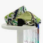 KABE SHOP INC Lunverde handmade bag with green fabric, intricate beaded strap, and long multi-colored fringe detail.