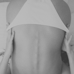 KABE SHOP INC Dolores tie bottom bikini brief in white, worn by a model in a minimalist black and white studio shot.