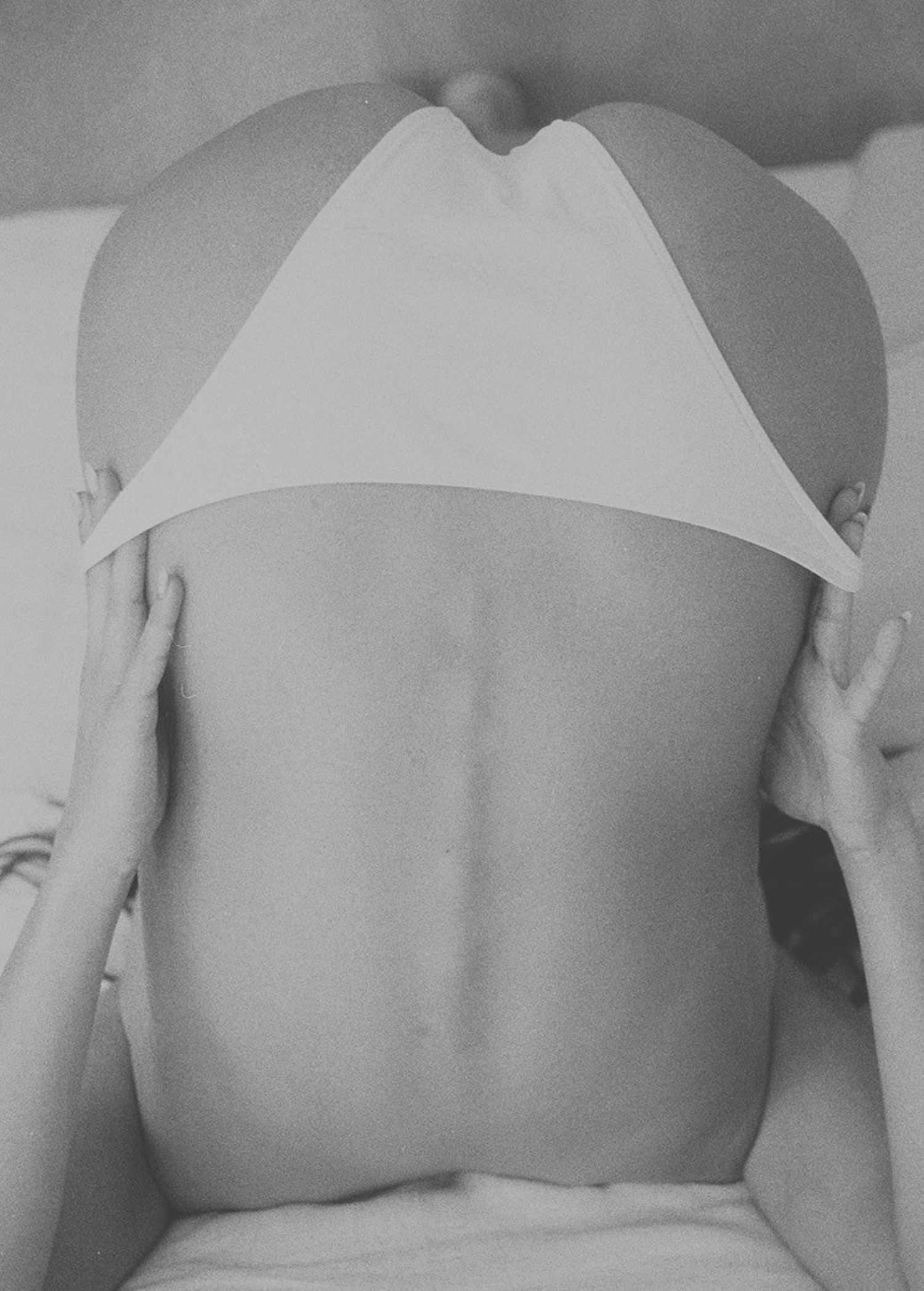 KABE SHOP INC Dolores tie bottom bikini brief in white, worn by a model in a minimalist black and white studio shot.