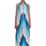 A person wearing The Halter Dress Small Point Collar, featuring a blue and white chevron pattern and expertly crafted from handwoven cotton that showcases Moroccan craftsmanship, stands facing forward against a plain white background.