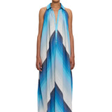 A person wearing The Halter Dress Small Point Collar, featuring a blue and white chevron pattern and expertly crafted from handwoven cotton that showcases Moroccan craftsmanship, stands facing forward against a plain white background.