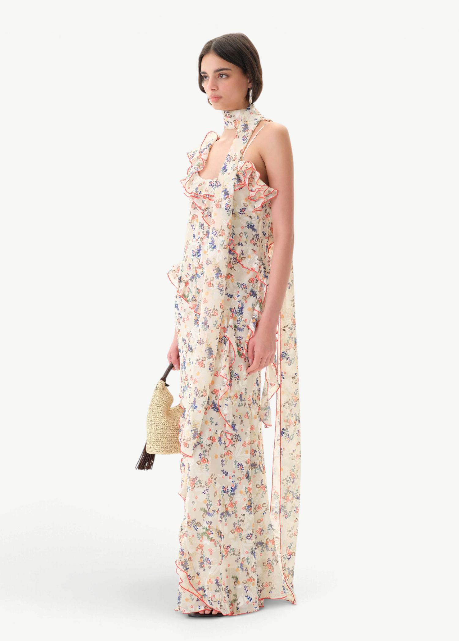 Model wearing KABE SHOP INC Monica dress with floral print, ruffle details, and a detachable scarf on white background