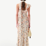 Back view of KABE SHOP INC Monica dress featuring floral print, ruffle details, and a matching detachable scarf.