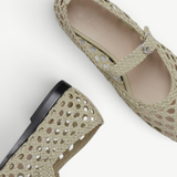 Two Mary Jane Woven Leather Shoes in beige handwoven goatskin are displayed on a white background—one shown from above and the other from the side—showcasing their intricate woven design and delicate buckle fastening on the slim strap.